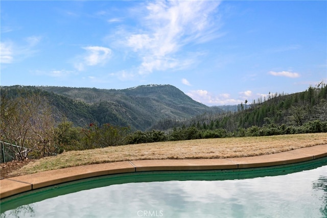 view of swimming pool with a mountain view