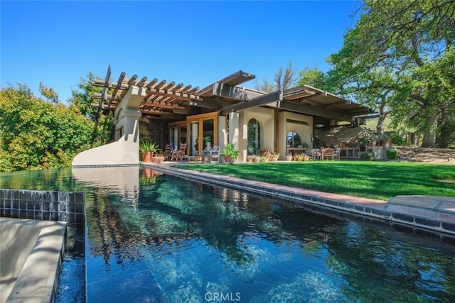 back of house with a pergola and a lawn