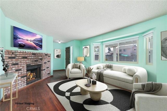 living room with a fireplace, dark wood-type flooring, and a textured ceiling