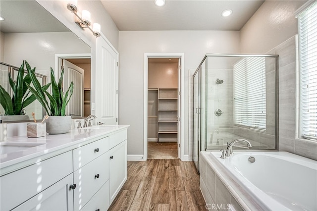 bathroom with vanity, hardwood / wood-style floors, and shower with separate bathtub