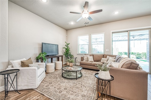 living room featuring hardwood / wood-style flooring and ceiling fan