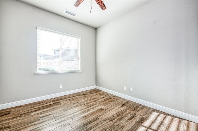 empty room with light hardwood / wood-style floors and ceiling fan