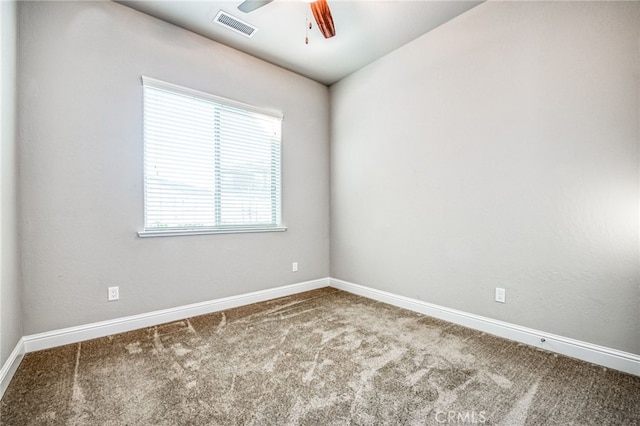 carpeted empty room featuring ceiling fan