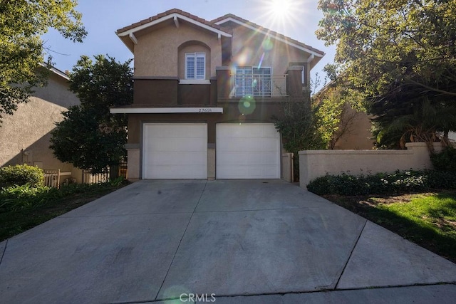 view of front property with a garage and a balcony