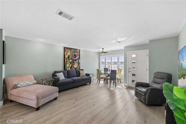 living room featuring ceiling fan and light hardwood / wood-style flooring