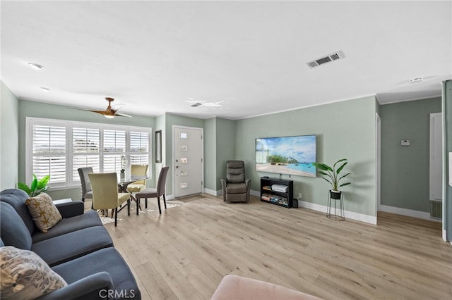 living room featuring ceiling fan and light hardwood / wood-style flooring