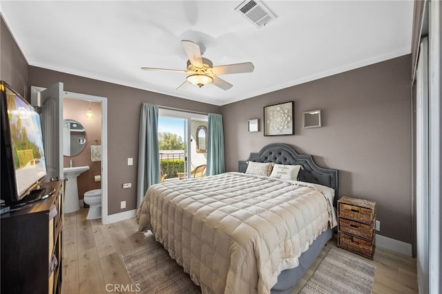 bedroom with crown molding, ensuite bathroom, access to exterior, and light wood-type flooring