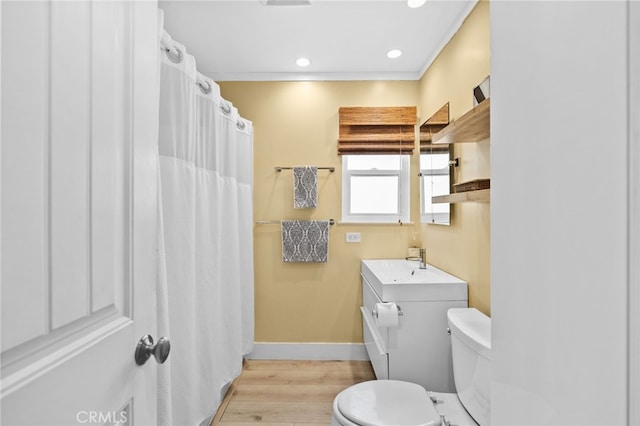 bathroom with crown molding, vanity, toilet, and hardwood / wood-style floors