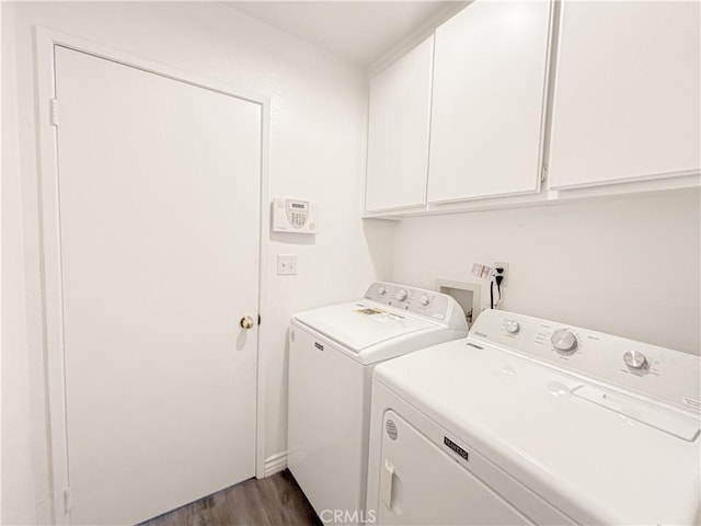 washroom with cabinets, separate washer and dryer, and dark hardwood / wood-style floors