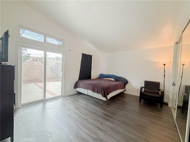 bedroom with lofted ceiling, hardwood / wood-style floors, and access to outside