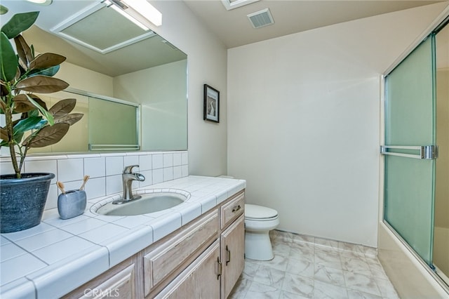 1585 W Riverglen Ave, Reedley, CA 93654 - full bathroom with tasteful backsplash, vanity, bath / shower combo with glass door, and toilet