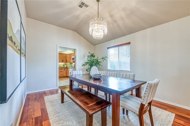 1585 W Riverglen Ave, Reedley, CA 93654 - dining area with lofted ceiling, a notable chandelier, and dark hardwood / wood-style floors