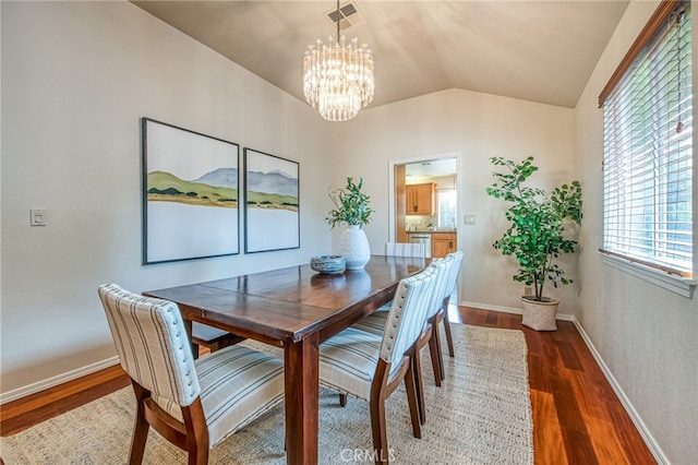 1585 W Riverglen Ave, Reedley, CA 93654 - dining area featuring dark wood-type flooring, vaulted ceiling, and a notable chandelier