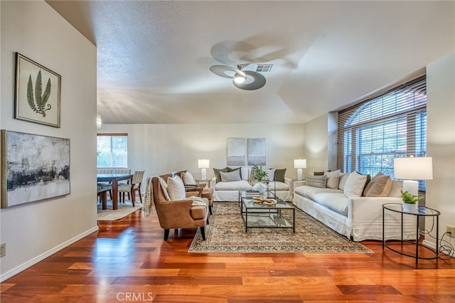 living room with hardwood / wood-style flooring and ceiling fan