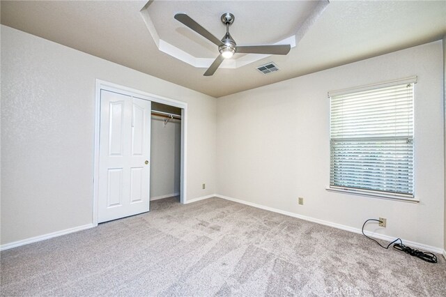 1585 W Riverglen Ave, Reedley, CA 93654 - unfurnished bedroom featuring light carpet, a tray ceiling, a closet, and ceiling fan