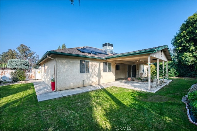 1585 W Riverglen Ave, Reedley, CA 93654 - back of property featuring ceiling fan, a yard, a patio area, and solar panels
