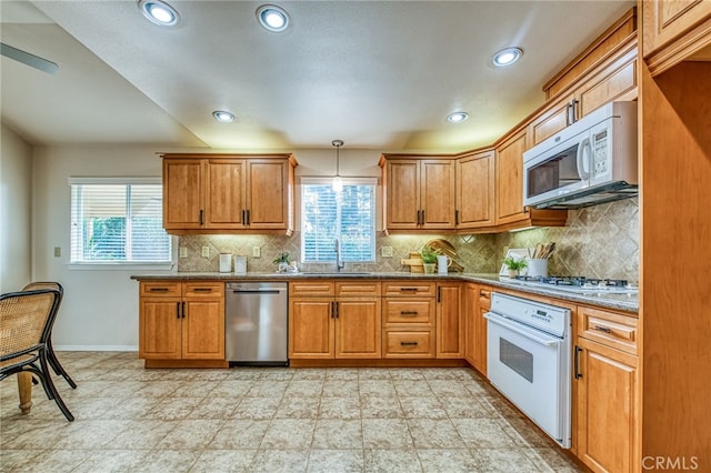 1585 W Riverglen Ave, Reedley, CA 93654 - kitchen with sink, hanging light fixtures, backsplash, plenty of natural light, and stainless steel appliances