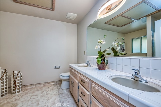 1585 W Riverglen Ave, Reedley, CA 93654 - bathroom with vanity, backsplash, and toilet