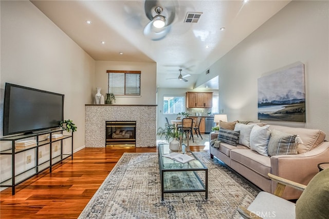 1585 W Riverglen Ave, Reedley, CA 93654 - living room with a tiled fireplace, wood-type flooring, and ceiling fan