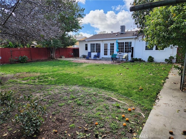 rear view of property featuring a yard and a patio area