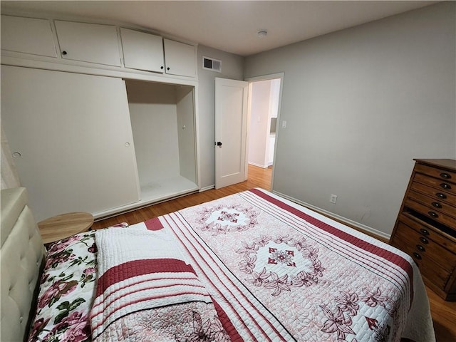 bedroom with wood-type flooring