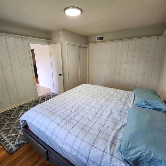 bedroom featuring hardwood / wood-style floors and a closet