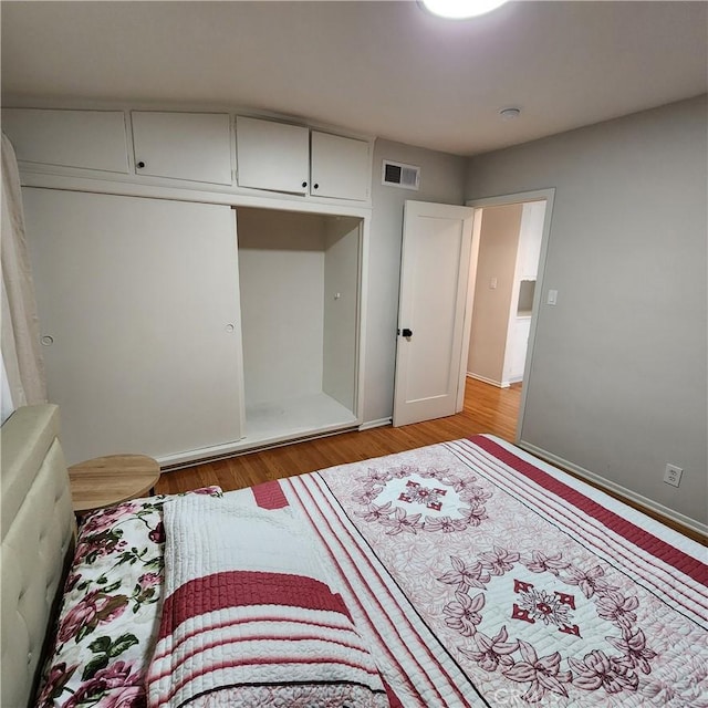 bedroom with a closet and light wood-type flooring