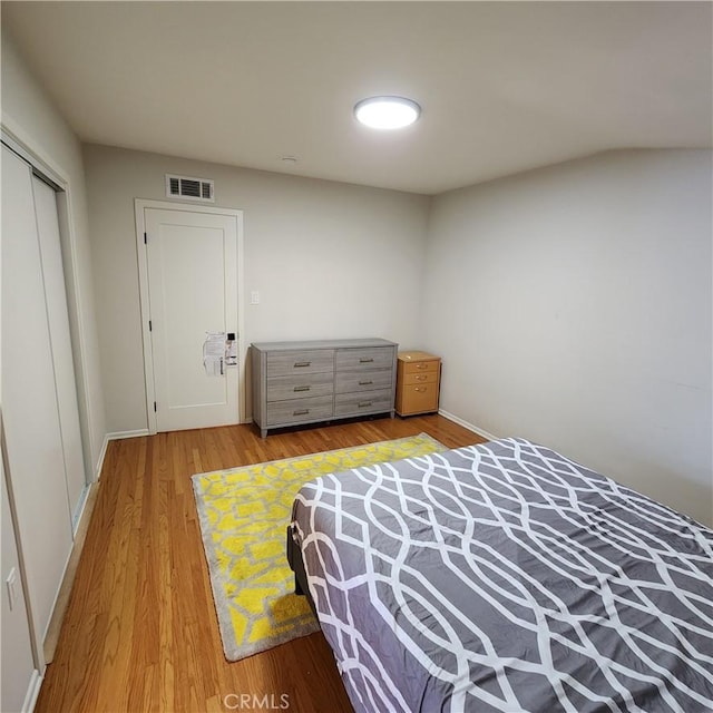 bedroom featuring wood-type flooring and a closet