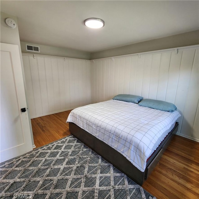 bedroom with dark wood-type flooring