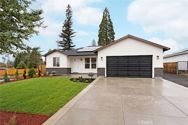 view of front of home featuring a garage, a front yard, and solar panels