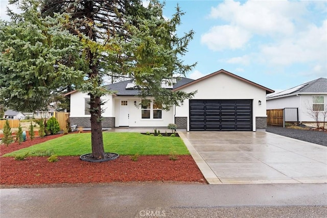 view of front of home featuring a garage and a front lawn