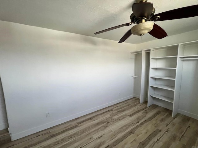 unfurnished bedroom featuring ceiling fan and light wood-type flooring