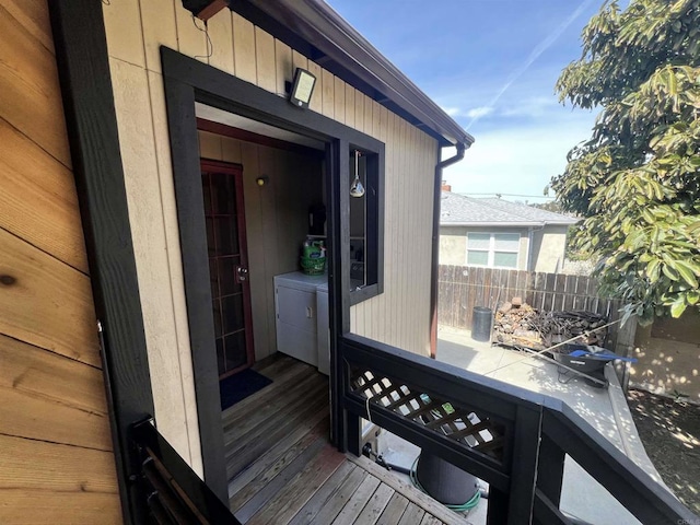 wooden terrace featuring washer and dryer