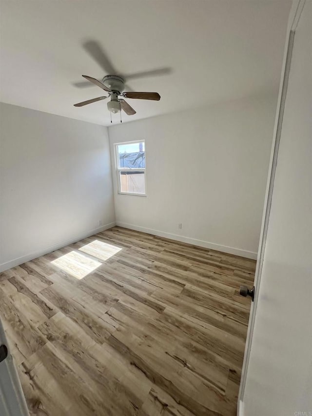 empty room featuring ceiling fan and light wood-type flooring