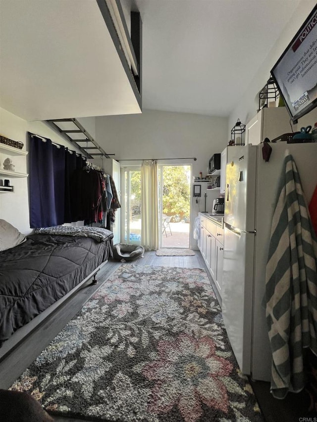 bedroom featuring access to outside and white fridge