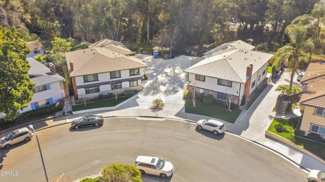 birds eye view of property with a wooded view and a residential view