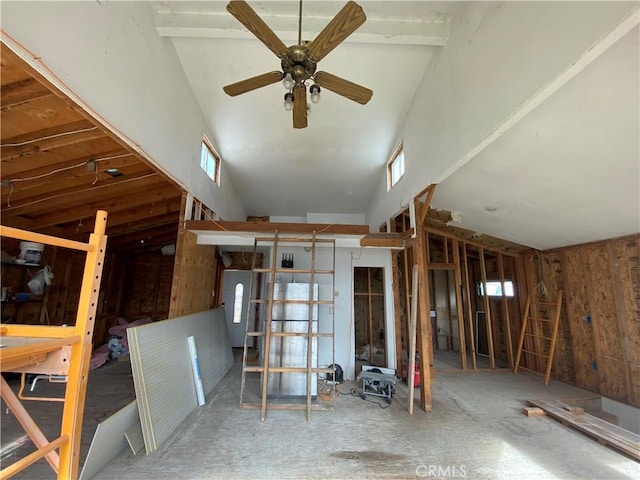 miscellaneous room with a towering ceiling, plenty of natural light, and ceiling fan