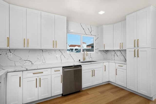 kitchen featuring white cabinetry, sink, and dishwasher