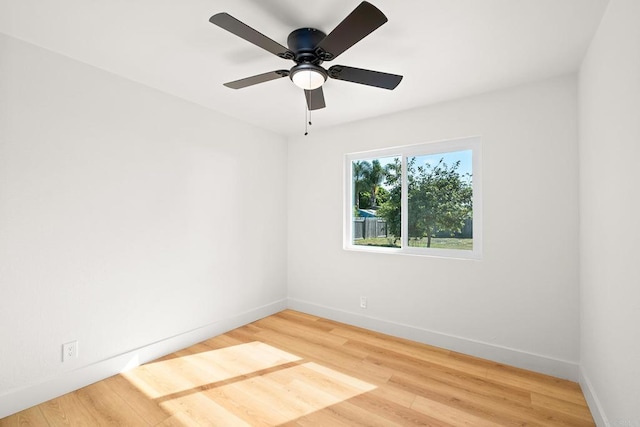 empty room with hardwood / wood-style floors and ceiling fan