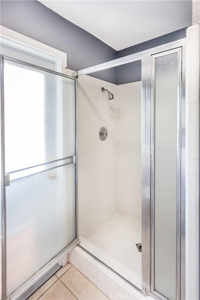 bathroom featuring a stall shower and tile patterned flooring