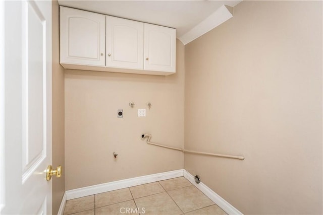 laundry room featuring light tile patterned floors, cabinet space, gas dryer hookup, electric dryer hookup, and baseboards