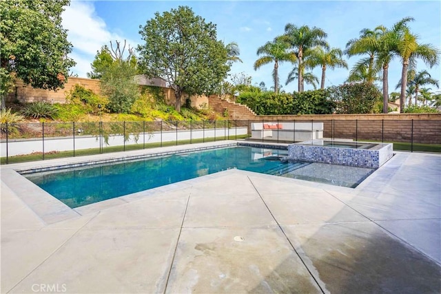 view of pool with a fenced in pool, a patio area, a fenced backyard, and an in ground hot tub