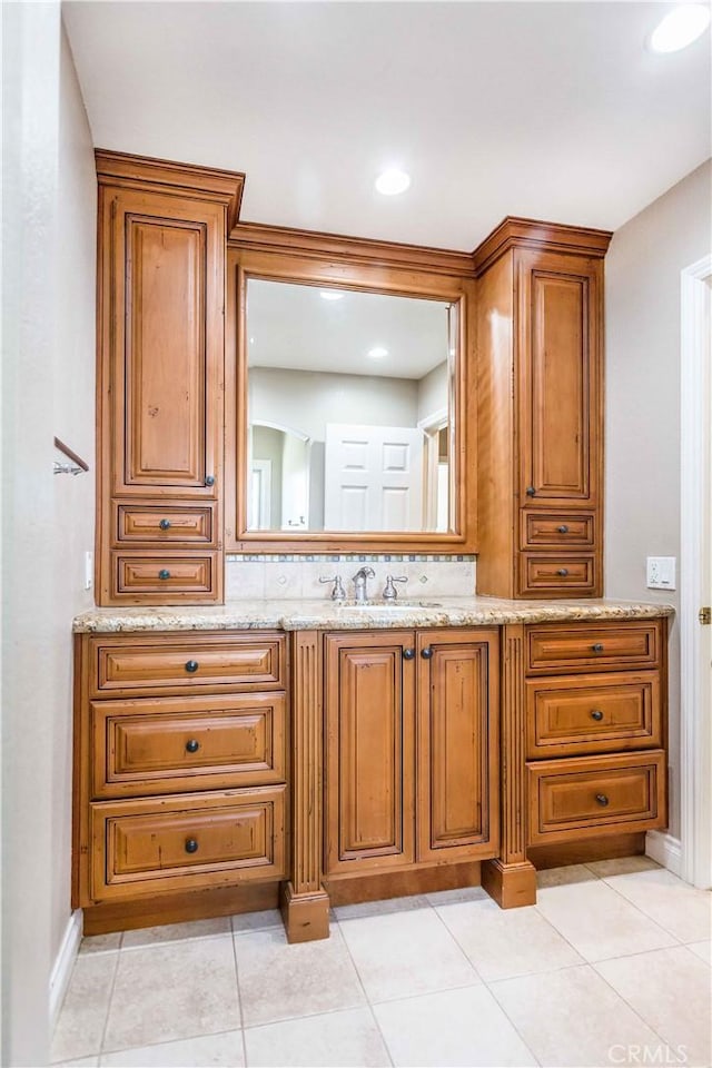 bathroom with tile patterned flooring and vanity