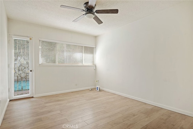 spare room with light hardwood / wood-style flooring, ceiling fan, and a textured ceiling