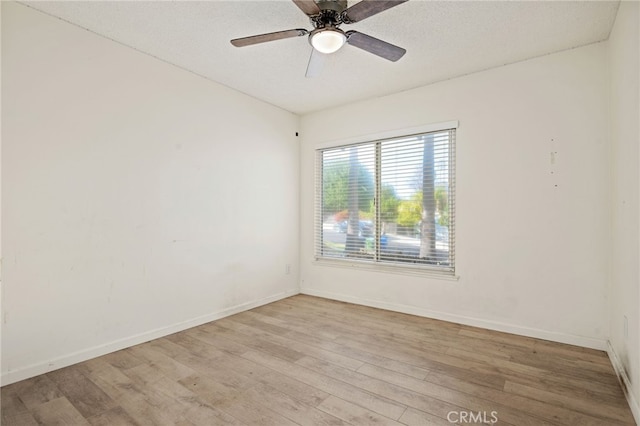 unfurnished room with light wood-type flooring, a textured ceiling, and ceiling fan