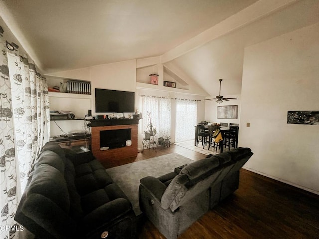 living room with lofted ceiling with beams, hardwood / wood-style floors, and a fireplace