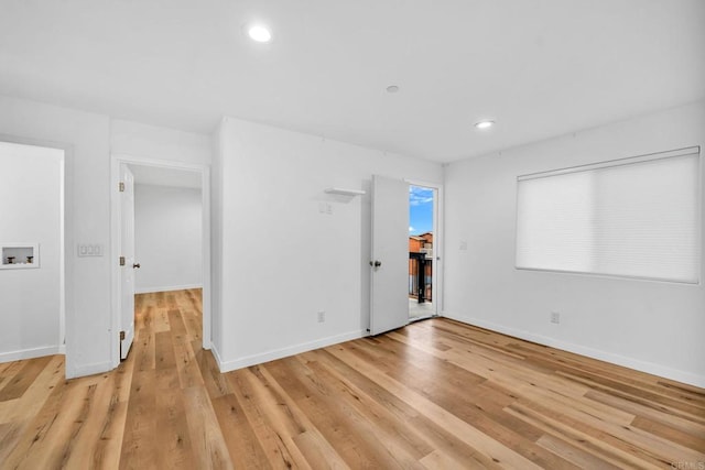 unfurnished room with light wood-type flooring