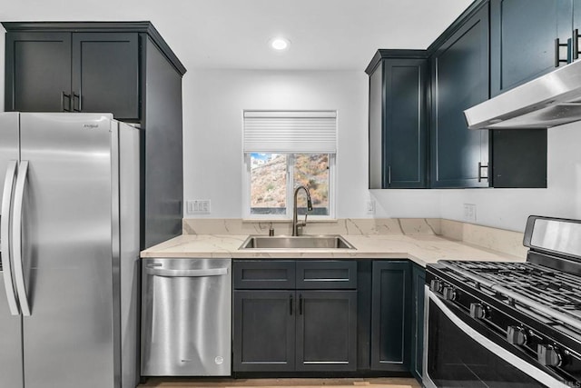 kitchen with sink, stainless steel appliances, and light stone counters