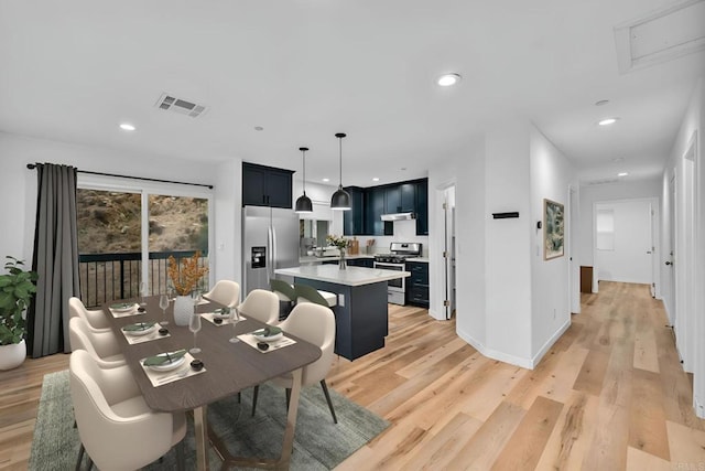 dining space featuring light wood-type flooring