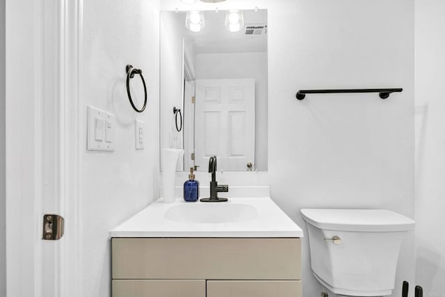 bathroom with toilet and vanity